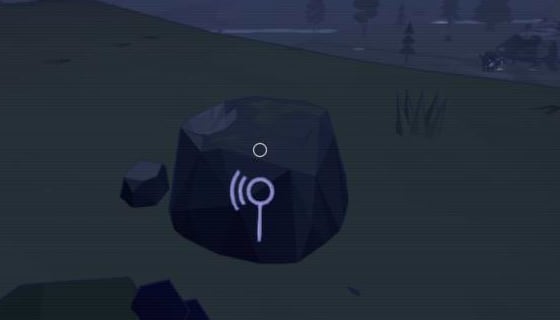 A dark boulder at night with a glowing violet glyph of a listening ear carved into it
