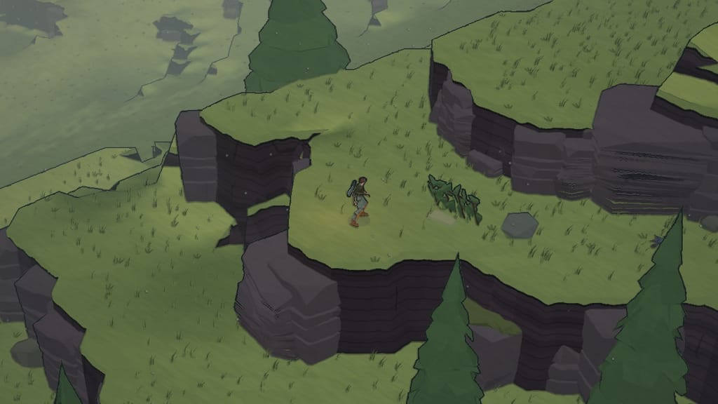 The explorer on a grassy ledge above the cliffs beside a low hide of cut boughs
