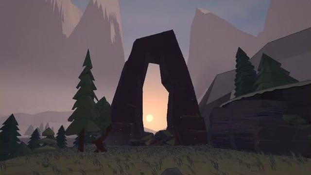 The rising sun framed inside a tall natural stone arch